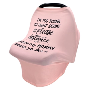 Close-up of pink nursing cover featuring humorous black printed text for car seat safety