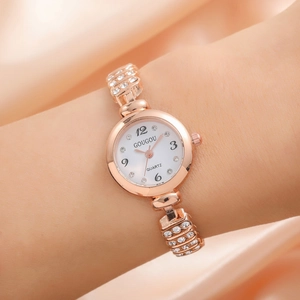 Elegant rose gold rhinestone quartz watch for women with white dial on silk background