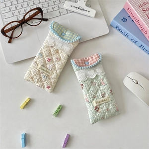 Detailed view of quilted cotton glasses pouches with lace trim and heart buttons