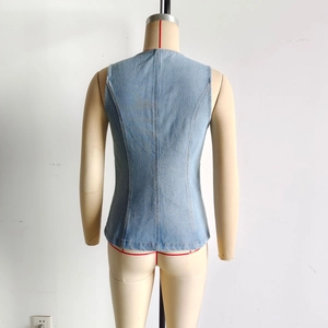 Detail view of the light blue denim vest back showing high quality fabric and stitching