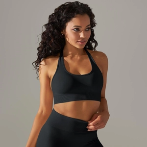 Detail of black seamless knitted yoga set showing halter neck bra and high waist leggings