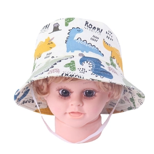 Detail of baby sun hat with colorful dinosaur prints and adjustable windproof strap