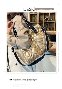 Detailed shot of quilted tote bag in metallic gold finish with a contrast strap