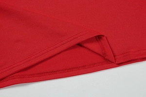Close-up of double-needle stitching on red knit dress hem with neat uniform seams