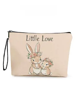 Detail of canvas makeup bag with rabbit print and Little Love lettering and wristlet