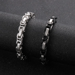 Detail of silver and black Byzantine style stainless steel chain bracelets for men