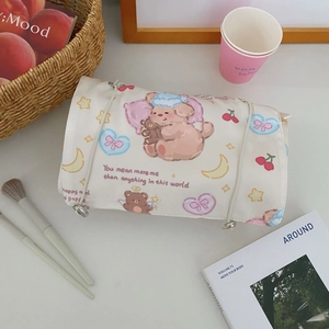 Detail of roll-up makeup bag with cartoon star puppy prints and cord closure