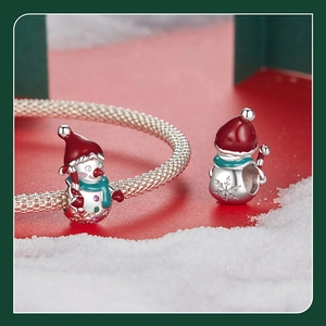 Close-up of S925 sterling silver snowman charm with red enamel and green scarf detail