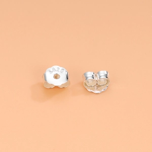Polished S925 sterling silver butterfly ear backs displayed on a warm orange background