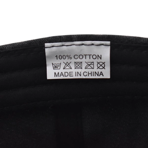 Detail shot of internal wash care label showing 100% cotton material and cleaning icons
