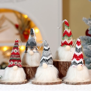 Detail showing five knitted Christmas gnomes with plush beards on wooden bases