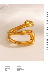 Artistic display of a gold hollow geometric ring with fluid lines and metallic luster