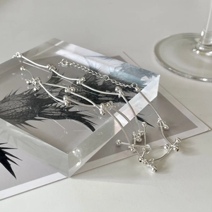 Detailed shot of minimalist 925 silver double ball chain on an acrylic display