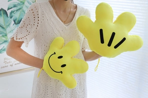 Detailed view of yellow plush cartoon palm gloves featuring smile and stripe patterns