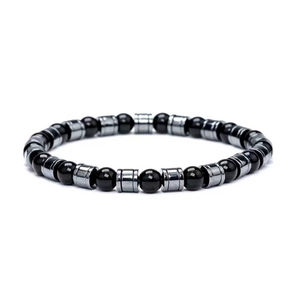 Close-up of black volcanic beads and silver cylindrical metal spacers on beaded bracelet