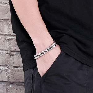 Close-up of a men's silver Cuban link bracelet made of durable stainless steel on wrist