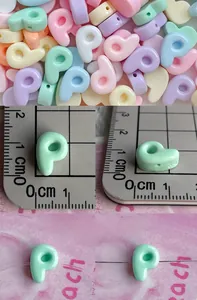 Macro shot of colorful 1cm resin alphabet beads with horizontal holes for DIY jewelry