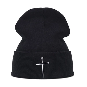 Retro black knit beanie with white cross embroidery for a minimalist streetwear style
