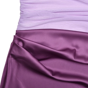 Detail of light purple mesh stitched with deep burgundy satin fabric on a backless dress