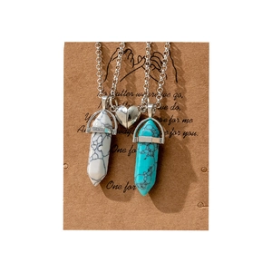 Couples magnetic necklaces with hexagonal stone pendants on a heart-shaped card
