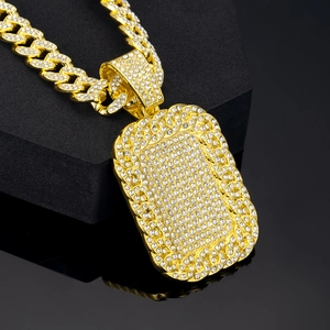 Close-up of iced-out gold Cuban link necklace with rectangle pendant on black stand