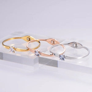 Three-piece set of polished steel bangles in gold, rose gold and silver with zircon