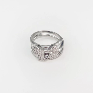 Detailed close-up of a silver butterfly ring featuring double bands and pavé zircons