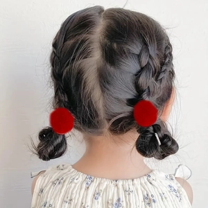 Pair of cute red fluffy pom pom hair ties for children's pigtail hairstyles