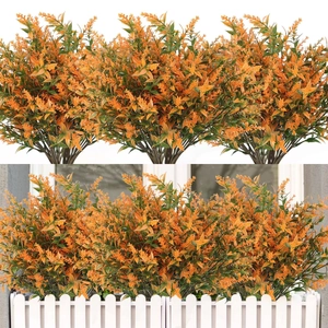 Detailed view of orange artificial lavender bouquet with white fence planter display