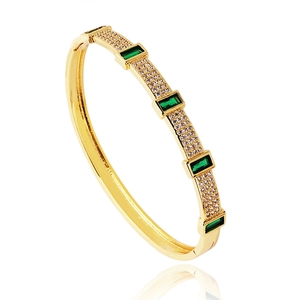 Luxurious gold-plated hinged bangle with rectangular green crystals and pavé cubic zirconia