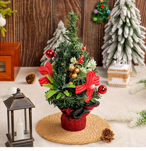 Close-up of mini Christmas tree with red berries, golden fruits, and festive bow decor