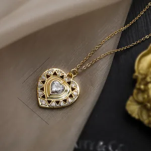 Macro shot of gold heart bear pendant with dimensions 3.1cm x 2.5cm and zircon details