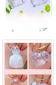 Detail view of transparent cat-shaped acrylic capsules with golden spiral metal keychains