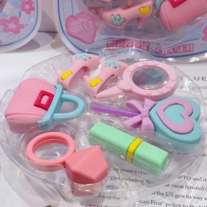 Detail of pink fashion accessory erasers set including high heels and handbag items