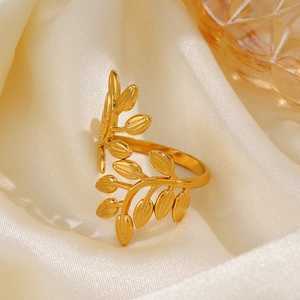 Golden stainless steel adjustable leaf ring with wrap-around foliage design on silk