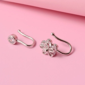 Detailed view of silver non-piercing copper nose rings with flower and round zircon studs