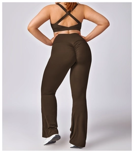 Detail of high-waist yoga pants with scrunch butt design and criss-cross sports bra