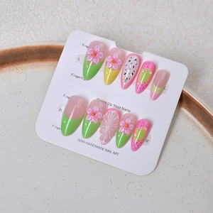 Detail of 3D floral press-on nails with pink dragon fruit gradients and pearl accents
