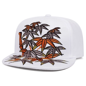 Detailed close-up of multi-color bamboo leaf embroidery on a white flat brim snapback hat