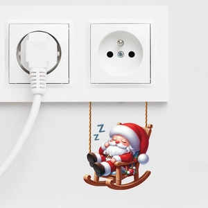 Cute sleeping Santa Claus wall sticker on a white wall near a power socket decoration
