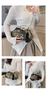Detail of vintage black shell bag with floral embroidery and elegant pearl chain strap