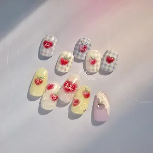 Detail view of 10pcs blue and white plaid nail stickers with heart and peach patterns