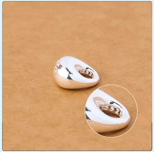 Detail of S925 sterling silver teardrop charm with LOVE engraving and polished finish