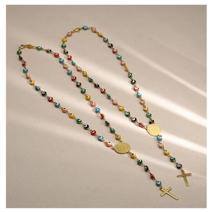 Detail of Turkish Evil Eye necklaces with colorful beads, St. Benedict medal, and golden cross