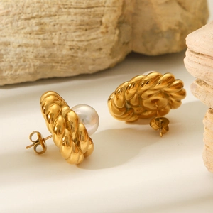 18K gold plated stainless steel twisted earrings with pearls on natural stone background