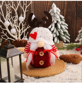 Detail of Christmas gnome with reindeer horns and heart detail on a festive winter background