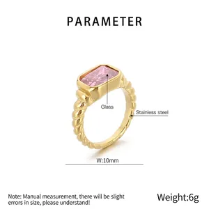 Detail of 10mm wide gold stainless steel twisted ring with rectangular pink glass stone