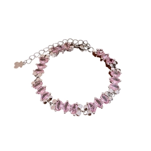 Elegant silver bracelet featuring oval pink gemstones and a bear charm on extension chain