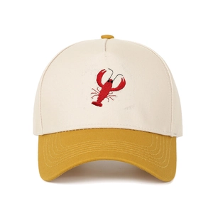 Close-up of lobster embroidery and contrast stitching on a cotton baseball cap