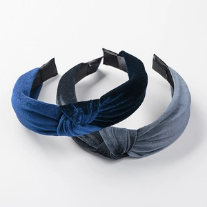 Three velvet knotted headbands in blue, dark grey, and light grey colors for women